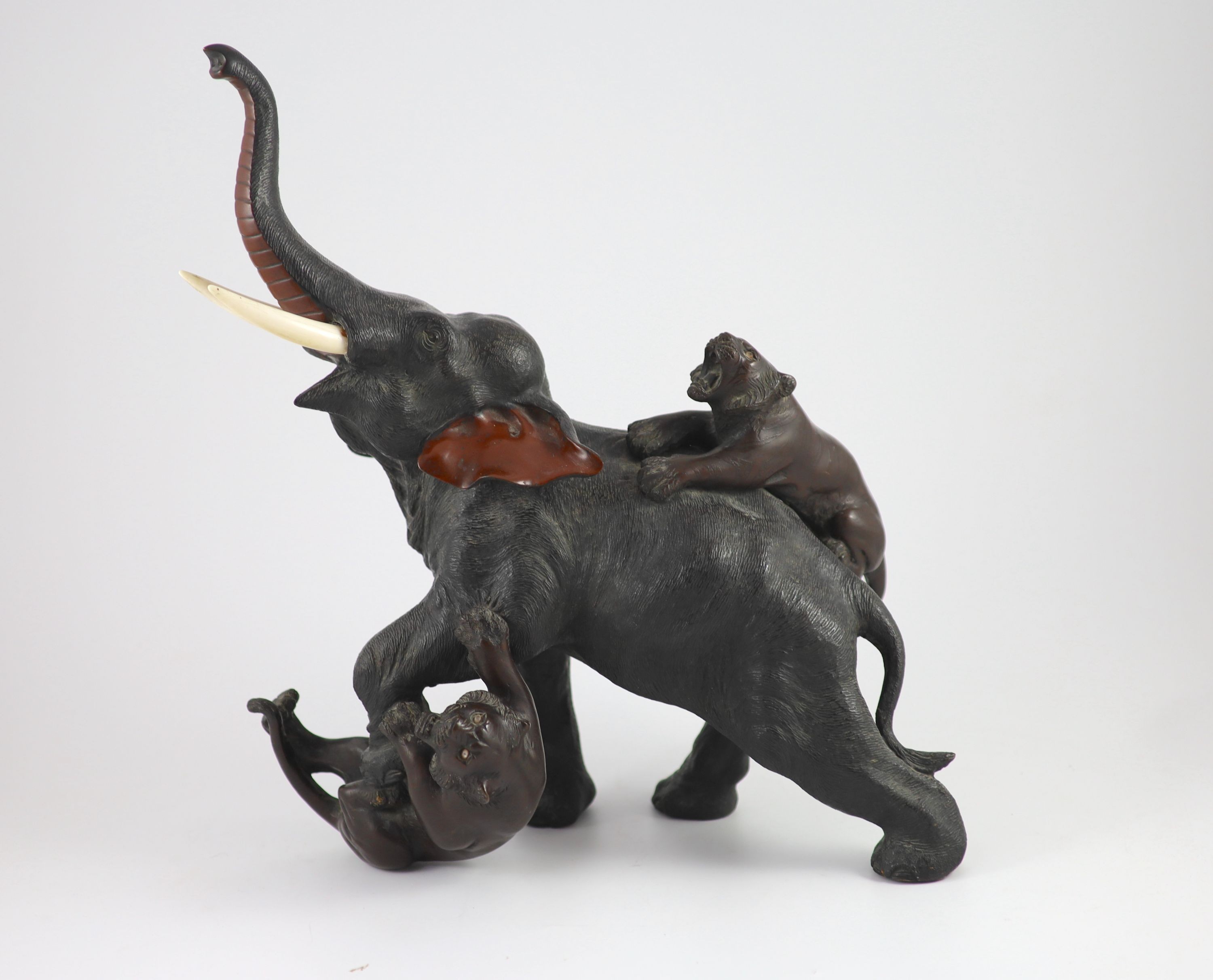 A good Japanese bronze elephant and tiger group, Meiji period signed Seiya saku, Total height 55cm and length 55cm including stand